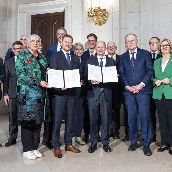 Kulturstaatsministerin Claudia Roth mit Bundeskanzler Olaf Scholz, den Regierungschefs der Länder und Hermann Parzinger bei der Unterzeichnung